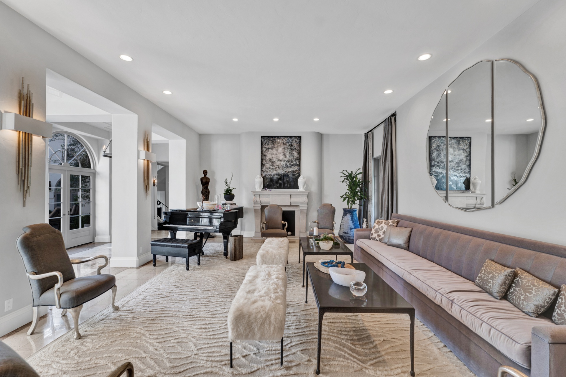 Formal living room with grand piano and stone fireplace