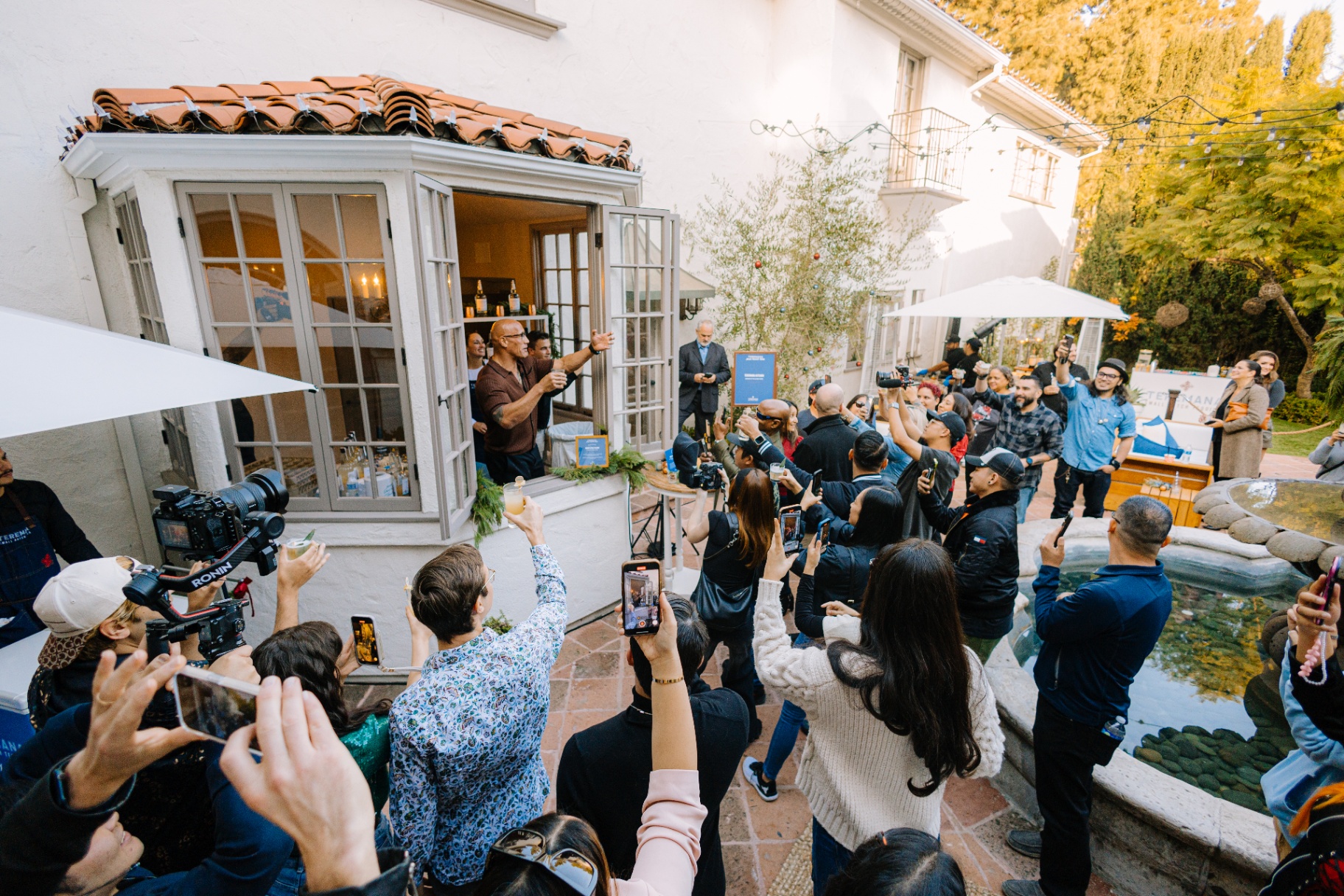 Dwayne Johnson greeting the crowd from the villa window