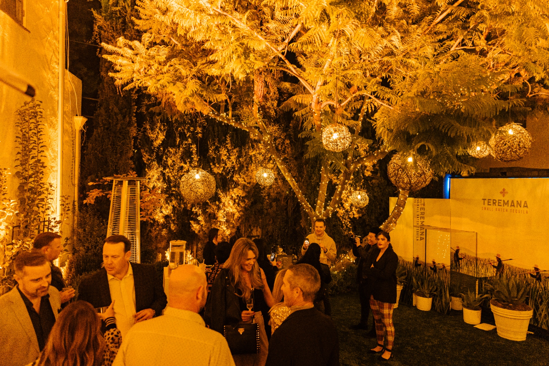 String lights and woven pendants above the garden lounge