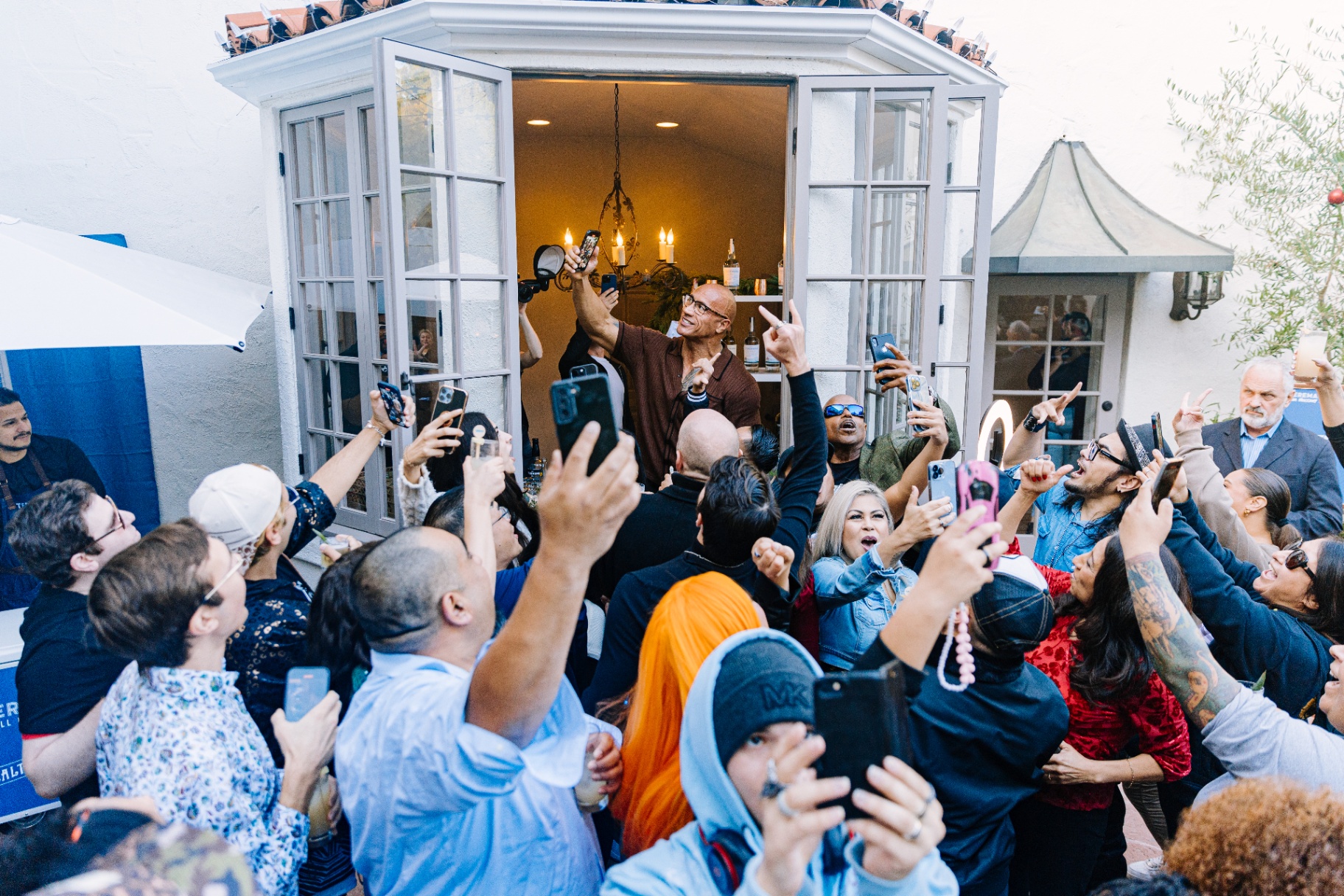 Guests cheering and taking selfies with Dwayne Johnson