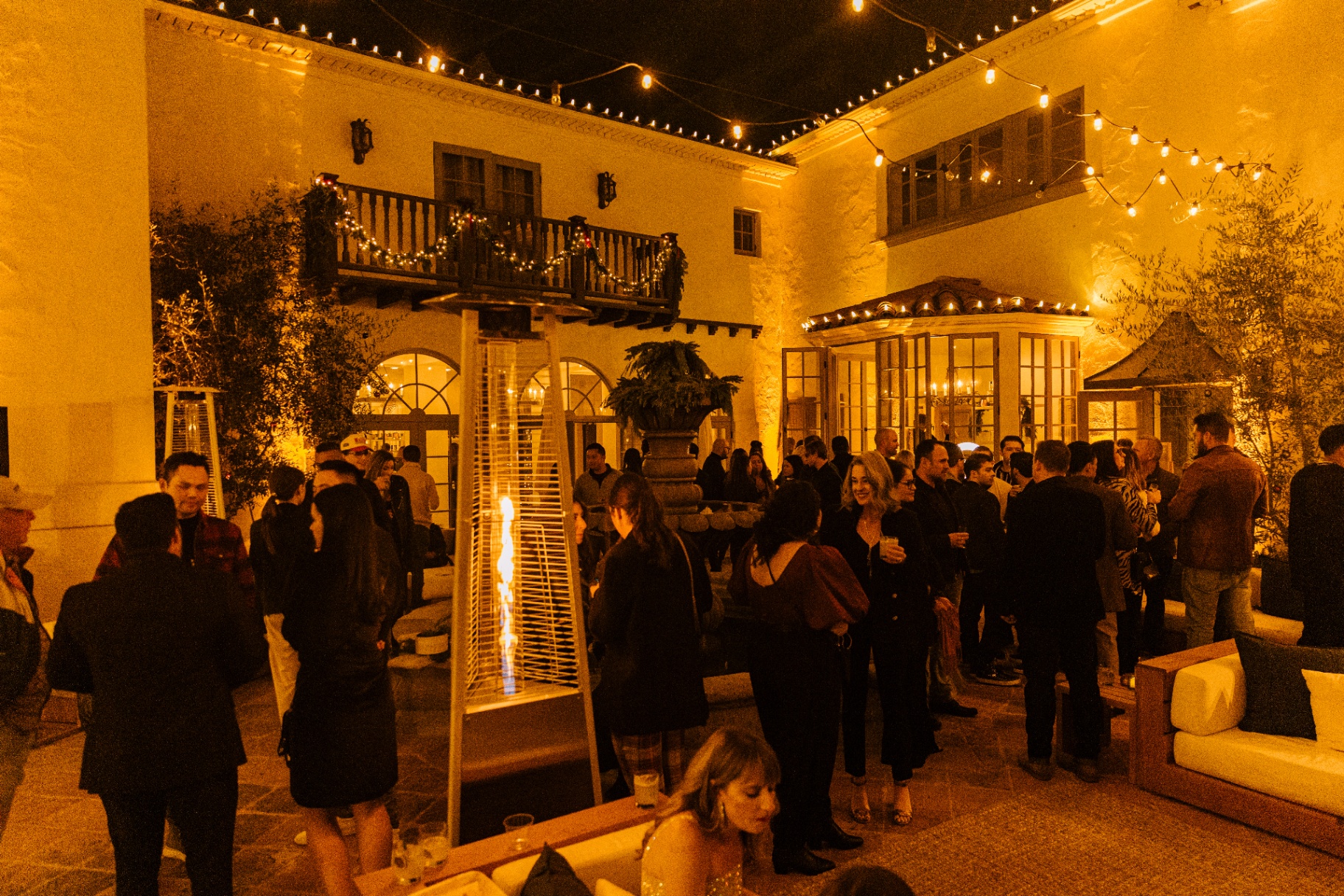 Cocktail crowd around the fountain courtyard at night