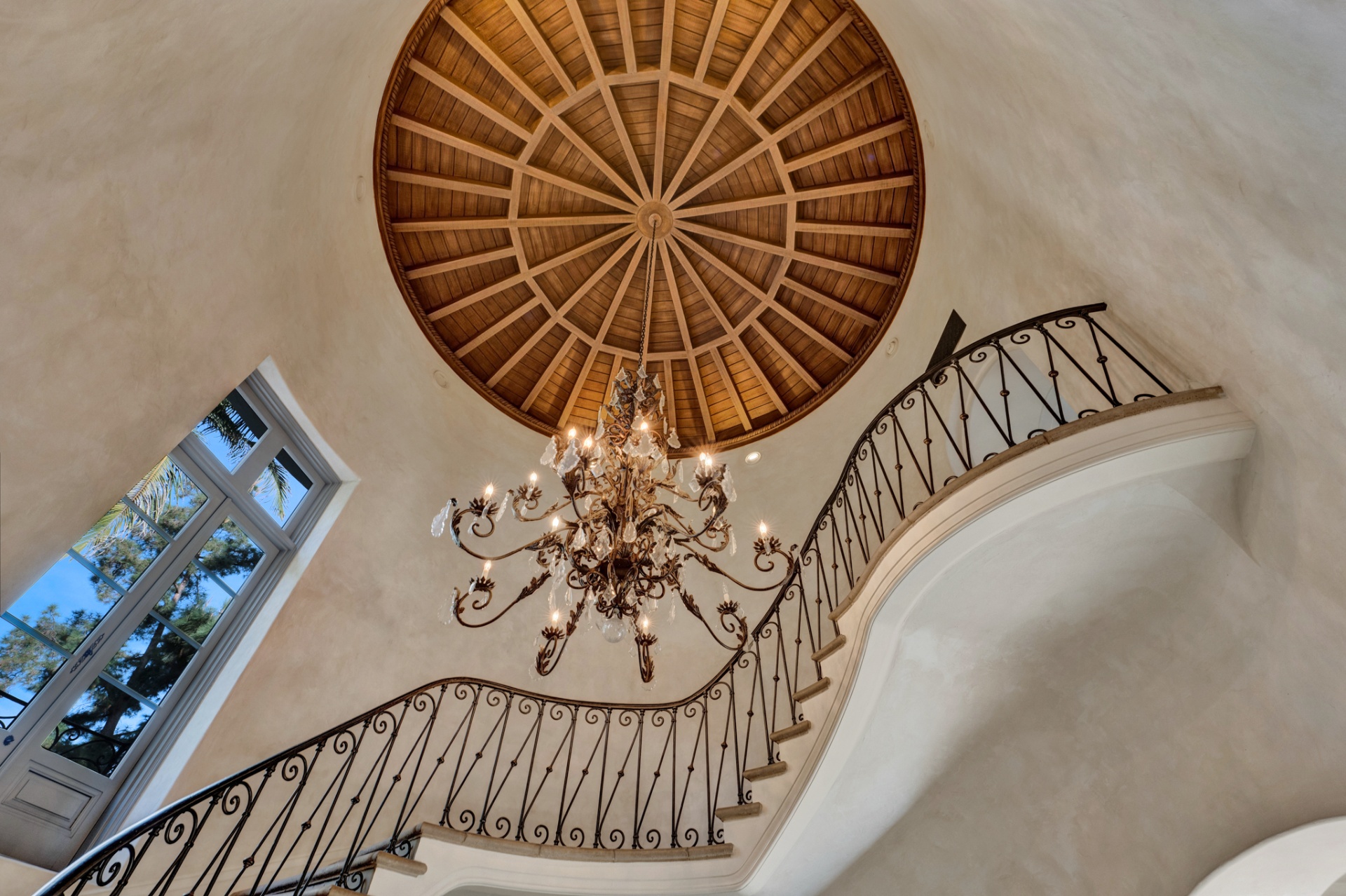 Domed wood-paneled rotunda above the staircase with wrought-iron chandelier